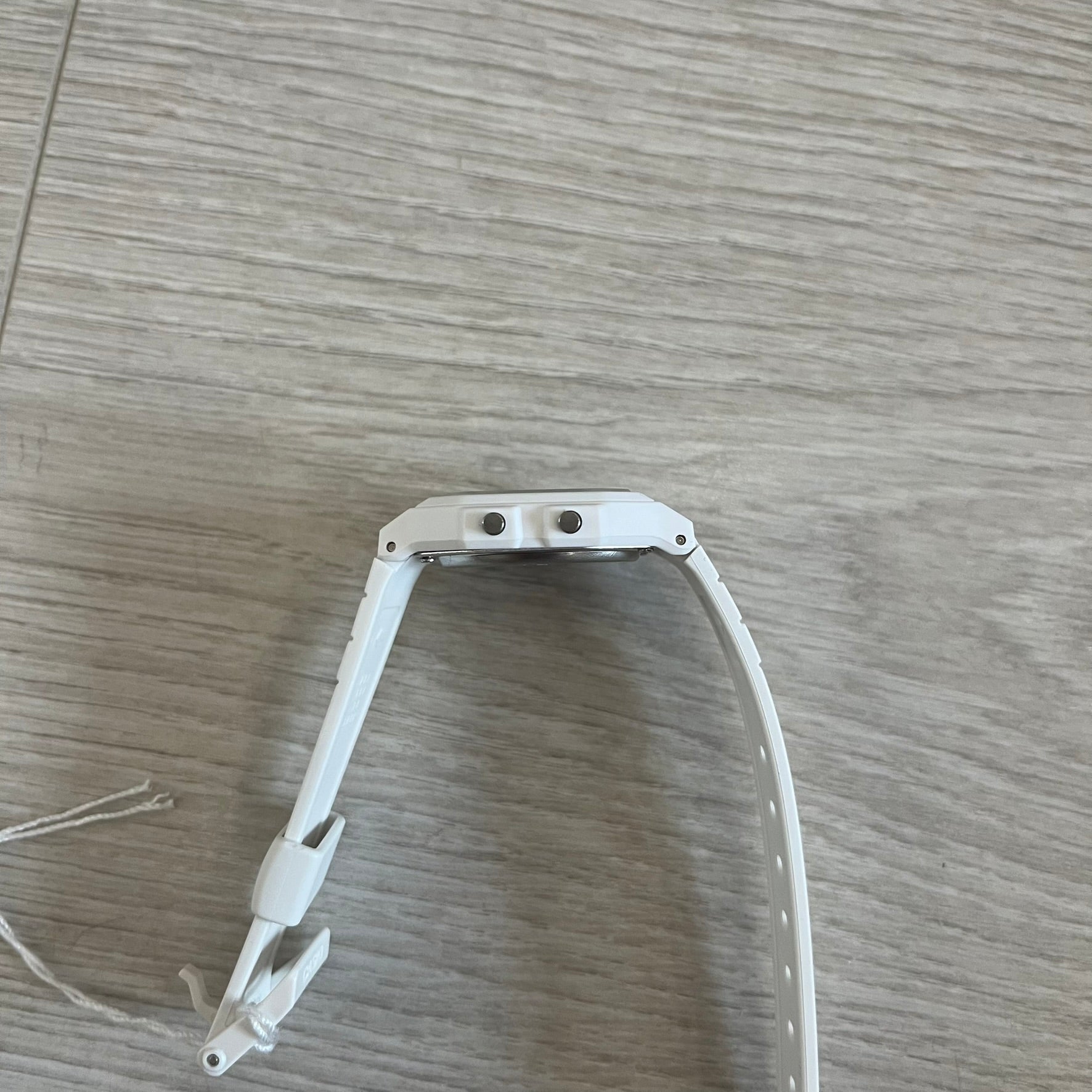 White metal bracket on a wooden surface