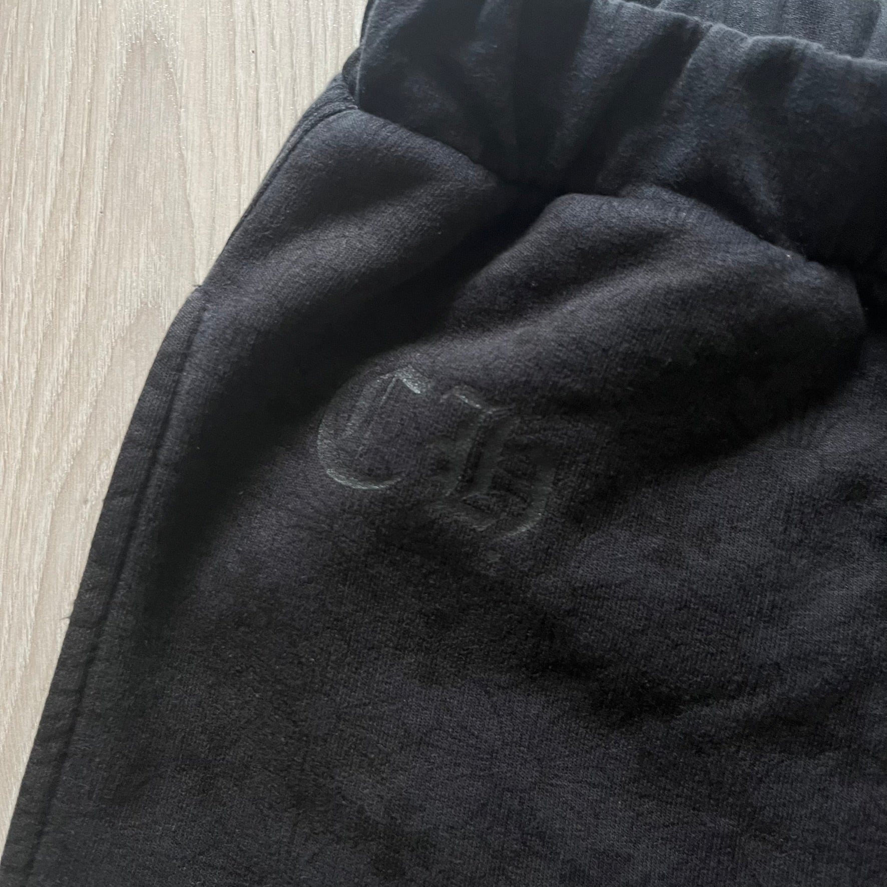 Close-up of a dark gray fabric texture on a wooden surface