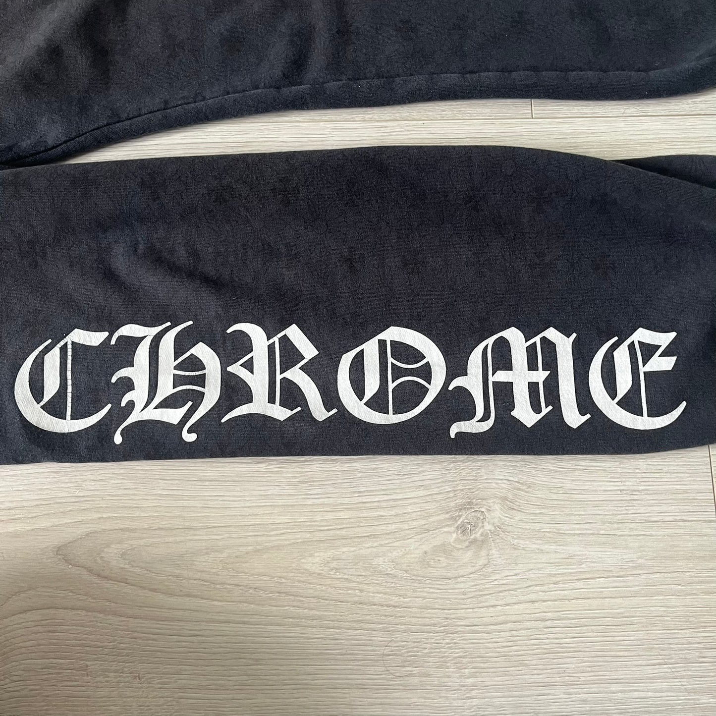 Black bag with 'CHROME' branding on a wooden surface