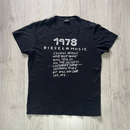 Black t-shirt with white text on a wooden surface