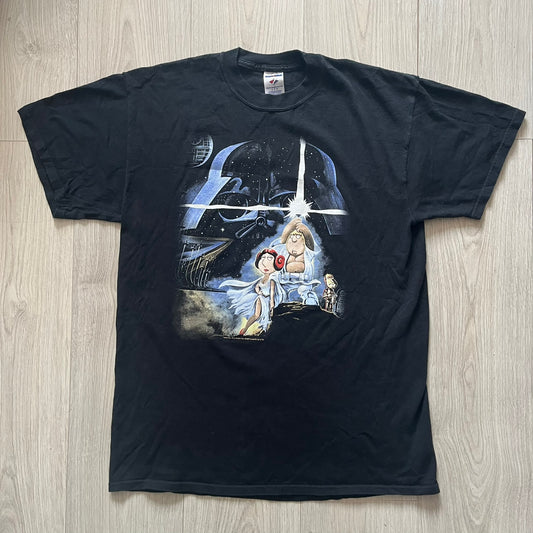 Black t-shirt with Star Wars-themed graphic on a wooden surface