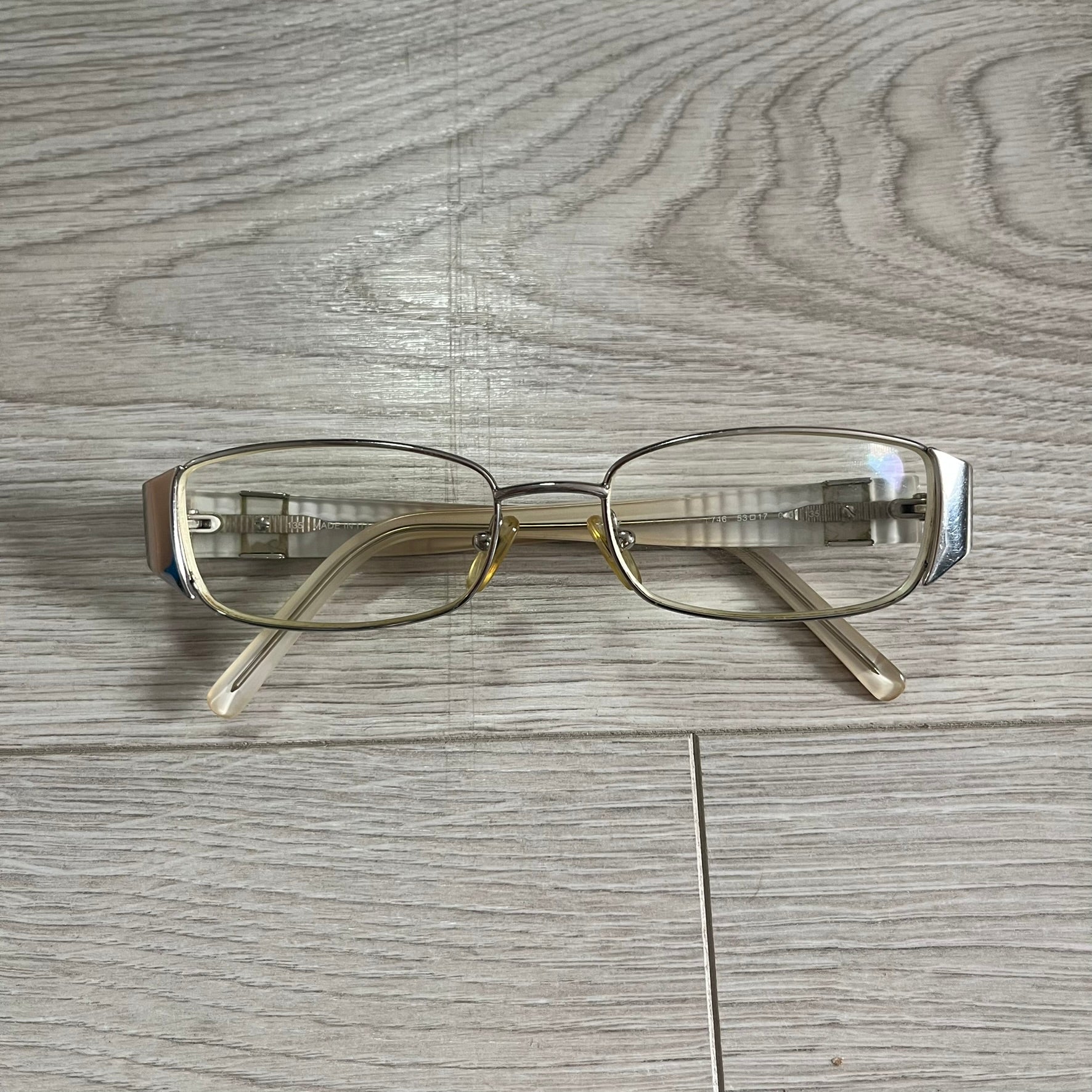 Pair of eyeglasses on a wooden surface