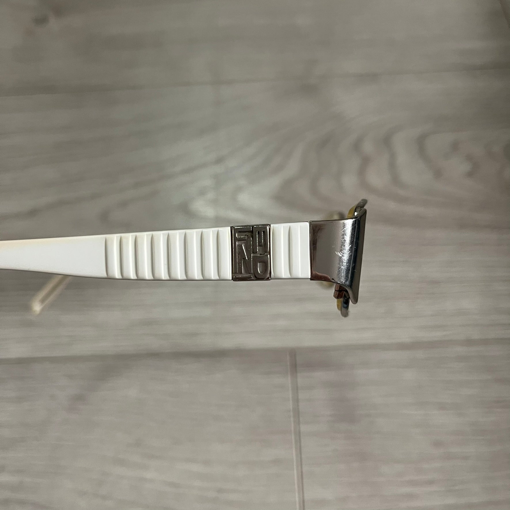 Metallic clip on a wooden surface