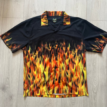 Black shirt with flame pattern on a wooden floor