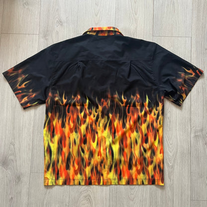 Black shirt with flame pattern on a wooden floor