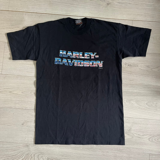 Black Harley-Davidson t-shirt on a wooden floor