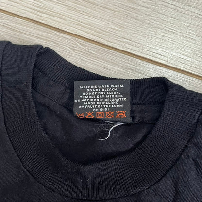 Black sweater with a label on a wooden surface