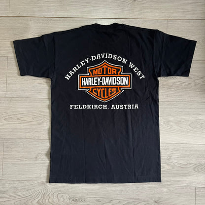 Black t-shirt with Harley-Davidson logo and text on a wooden surface