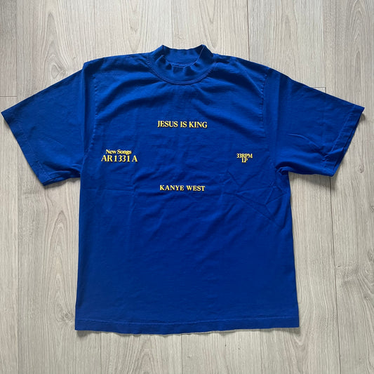 Blue t-shirt with text on a wooden surface