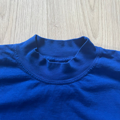 Close-up of a blue shirt collar on a wooden surface
