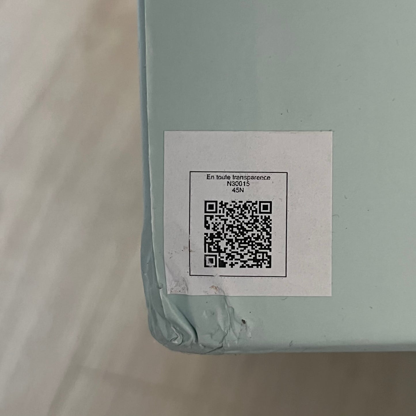Product with a QR code label on a light gray background