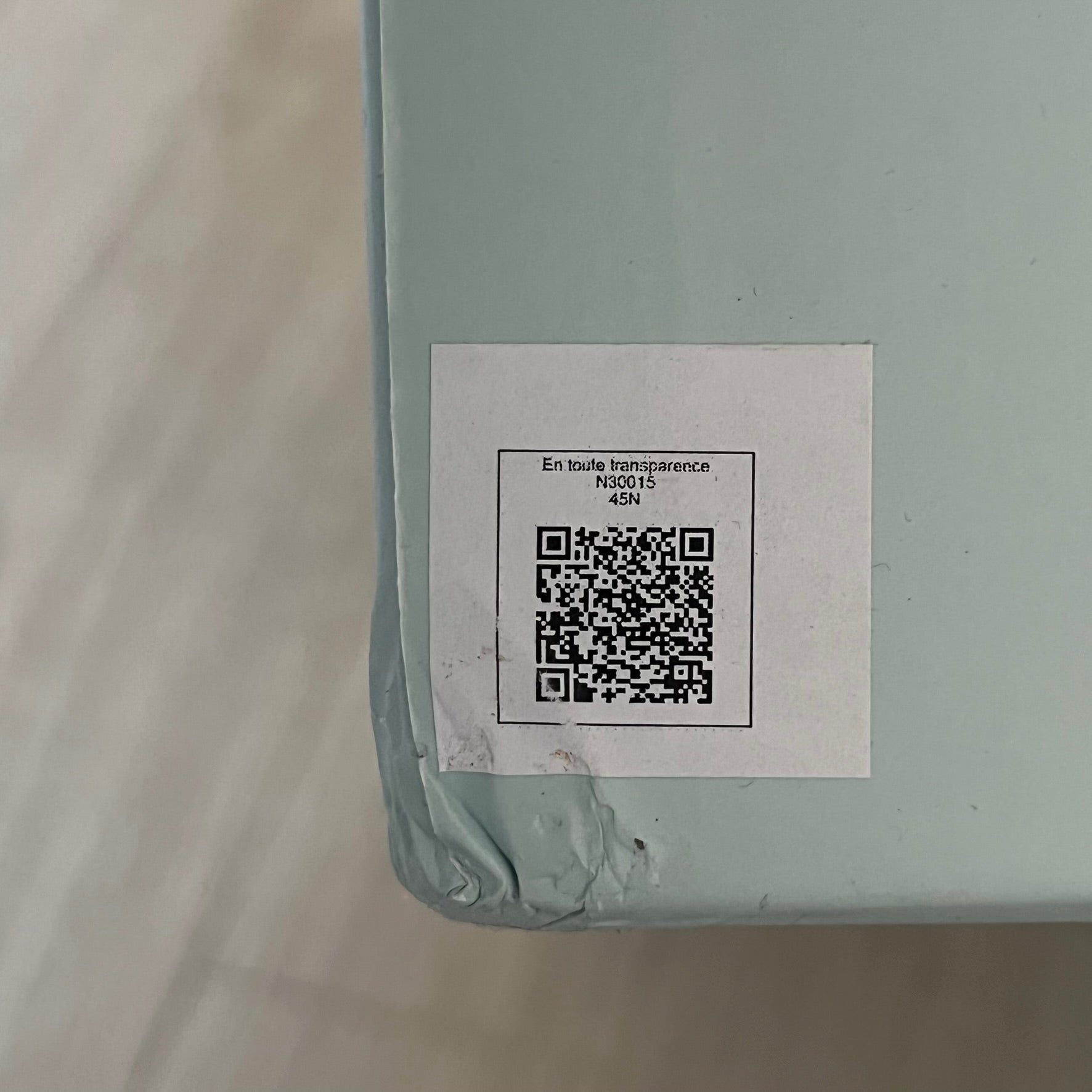 Product with a QR code label on a light gray background