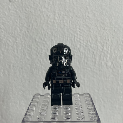Black LEGO minifigure on a clear baseplate against a white background