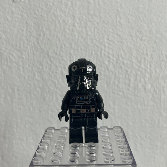 Black LEGO minifigure on a clear baseplate against a white background