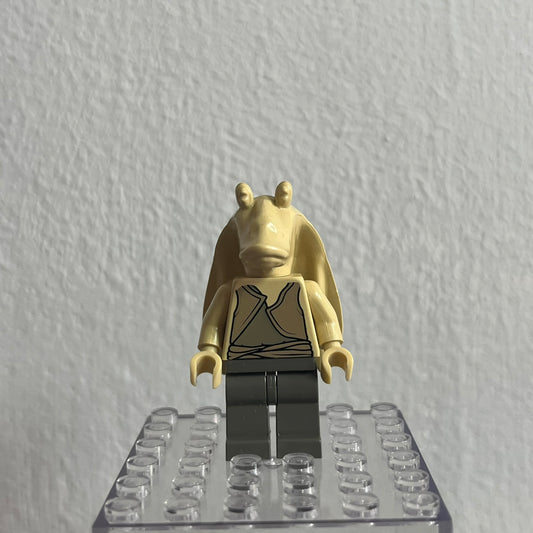 Gold-colored minifigure on a clear baseplate against a white background