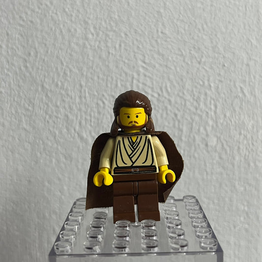 LEGO minifigure on a clear baseplate against a white wall