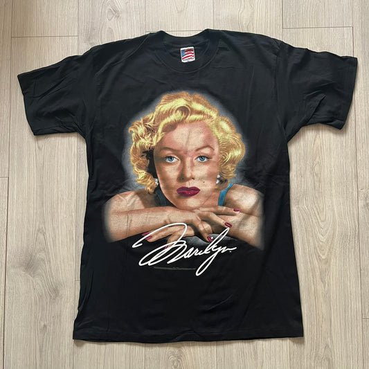 Black t-shirt with a graphic of a famous actress and signature on a wooden surface