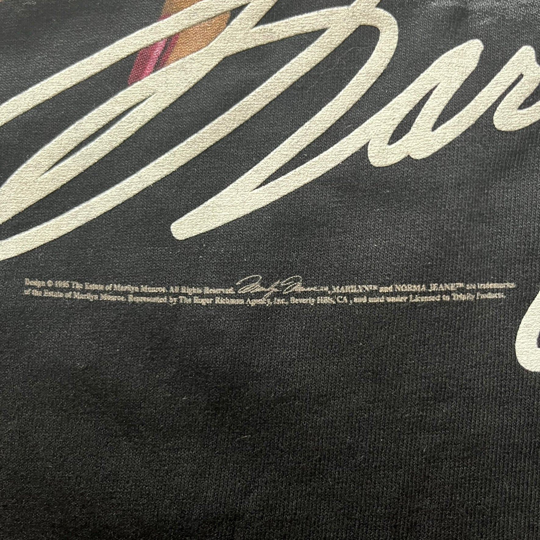 Black t-shirt with white text and logo on a black background