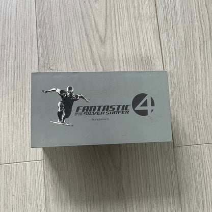 Box with 'Fantastic Four' logo featuring a character on a wooden floor