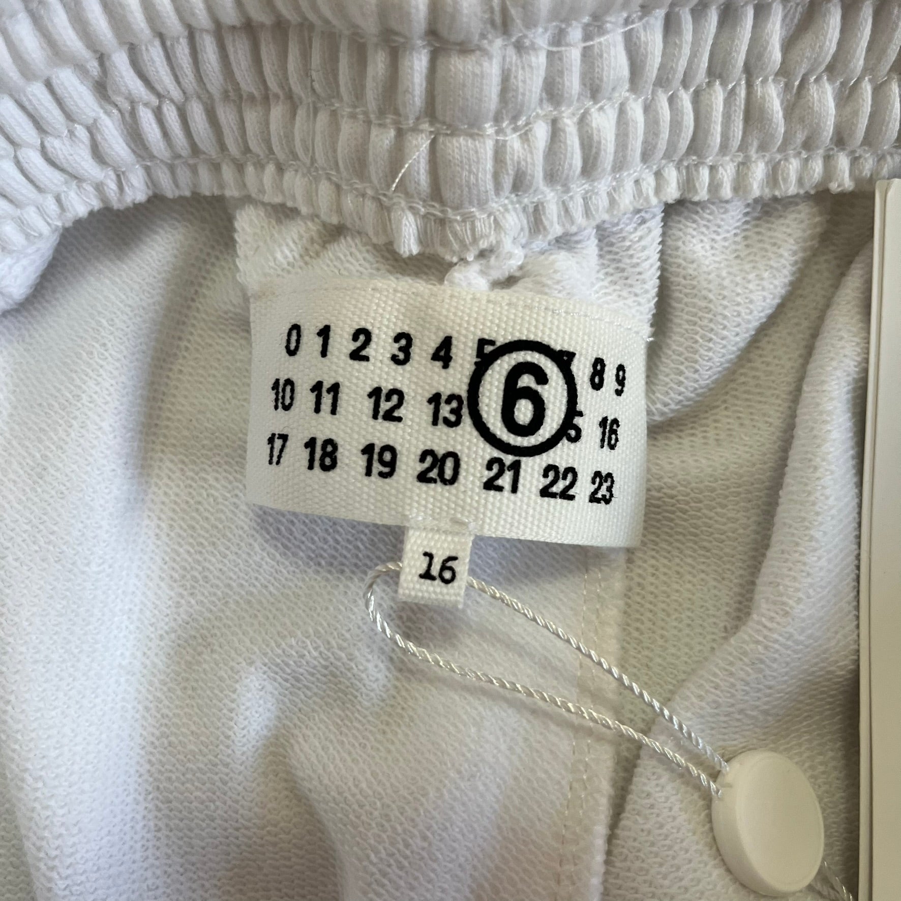 Close-up of a clothing tag on a textured fabric background