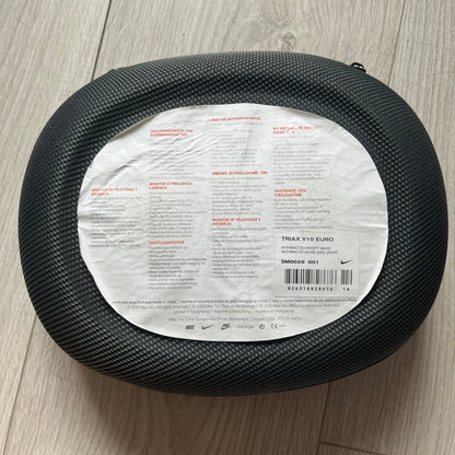 Black tire with a label on a wooden floor