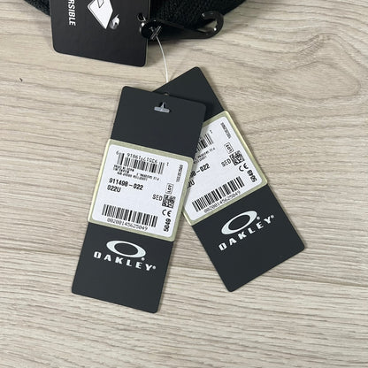 Oakley product tags with barcodes on a wooden surface