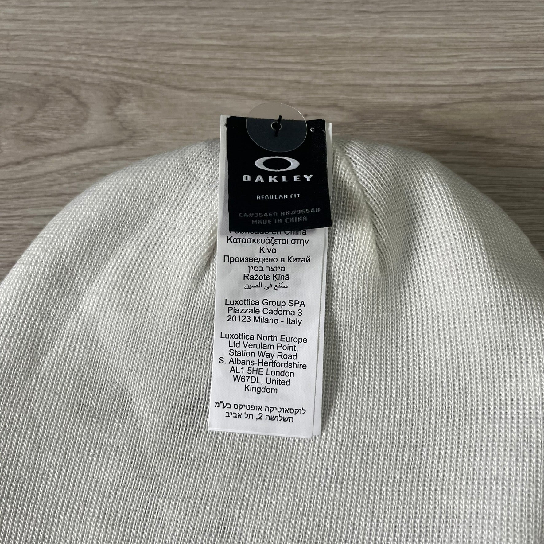 Gray beanie with Oakley tag on a wooden surface