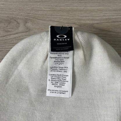 Gray beanie with Oakley tag on a wooden surface