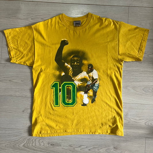 Yellow t-shirt with graphic design of a person in a football uniform and number 10 on a wooden floor.