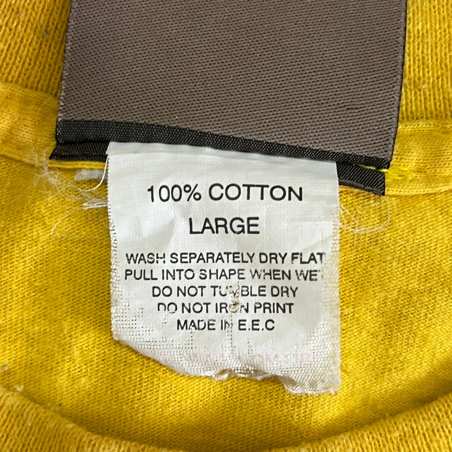 Clothing label on a yellow fabric with text details