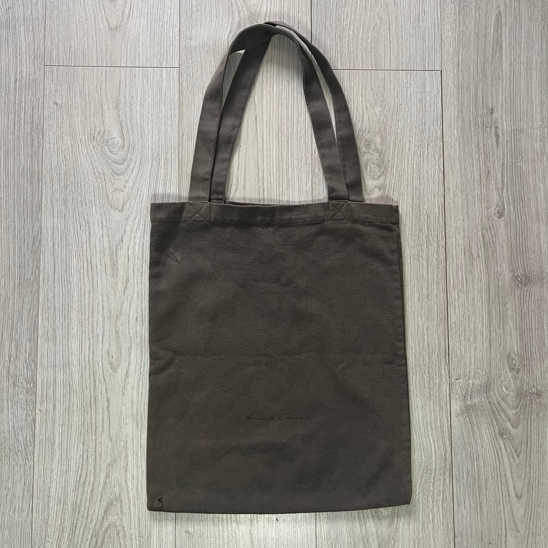 Black tote bag on a wooden surface