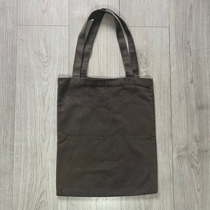 Black tote bag on a wooden surface