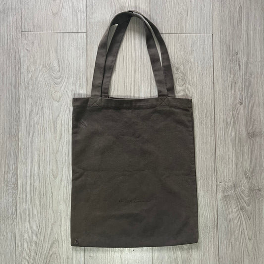 Black tote bag on a wooden surface