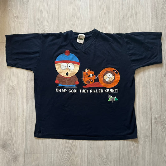 Black t-shirt with cartoon characters and text on a wooden surface