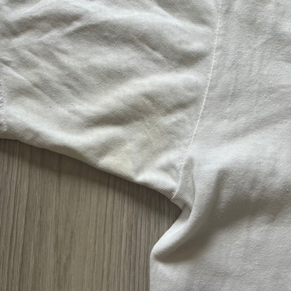 Close-up of a white fabric corner on a wooden surface