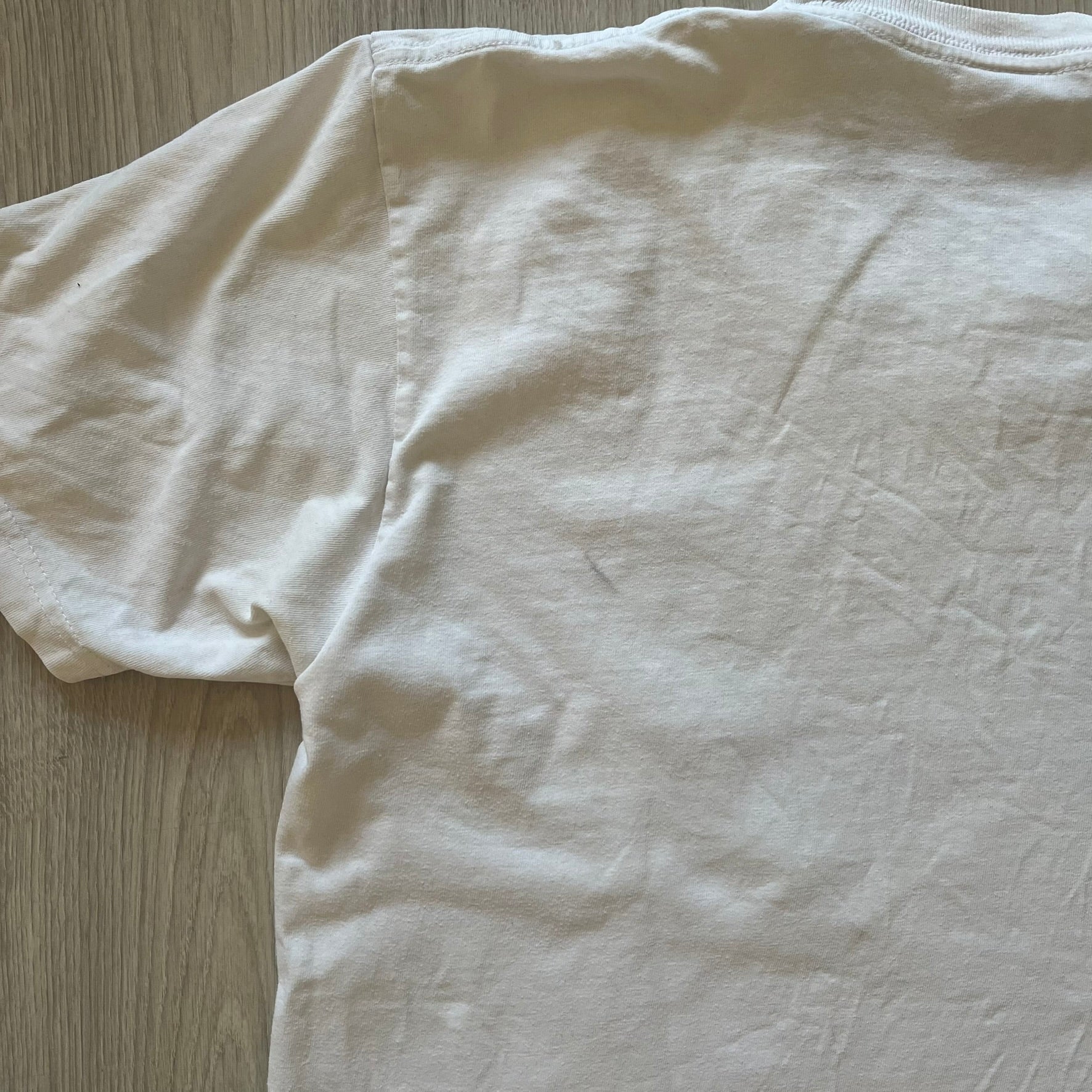 White t-shirt on a wooden surface