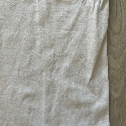Close-up of a light gray fabric with a wooden surface background