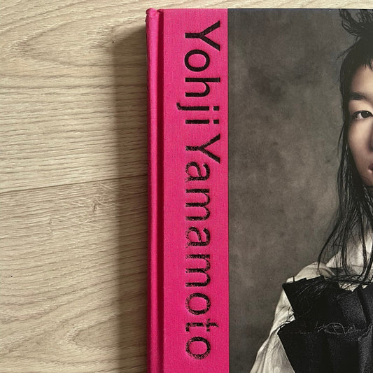 Yohji Yamamoto product with a person lying on a gray surface