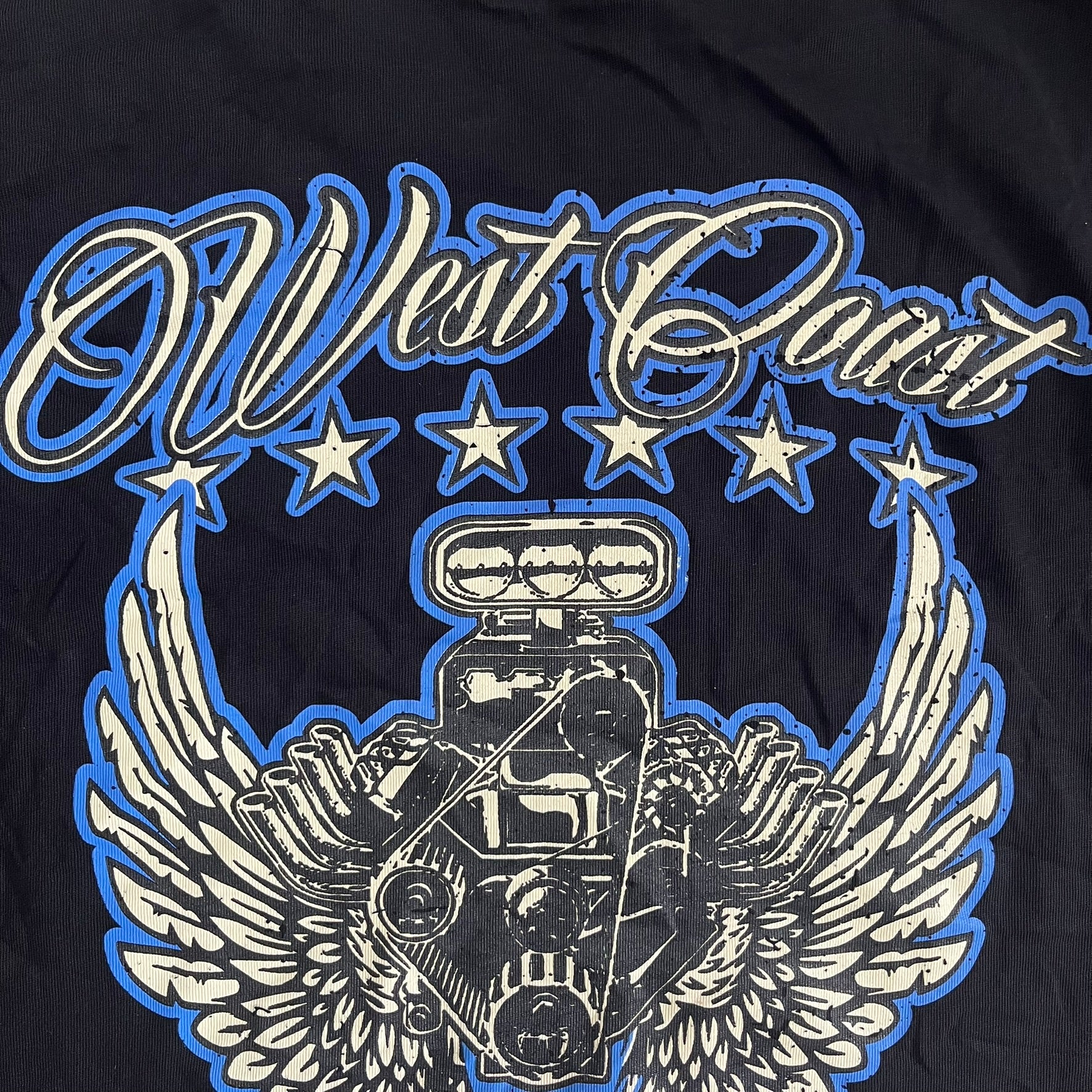 Black t-shirt with 'West Coast' design featuring a engine and wings on a dark background